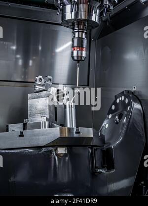 Quality control measurement probe. Metalworking CNC milling machine. Cutting metal modern processing technology. Stock Photo