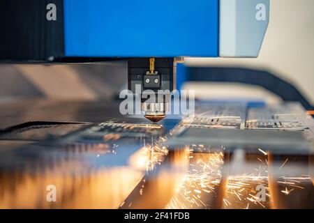 CNC Laser cutting of metal modern industrial technology. Laser cutting works by directing the output of a high-power laser through optics. Laser optics and CNC computer numerical control. Stock Photo