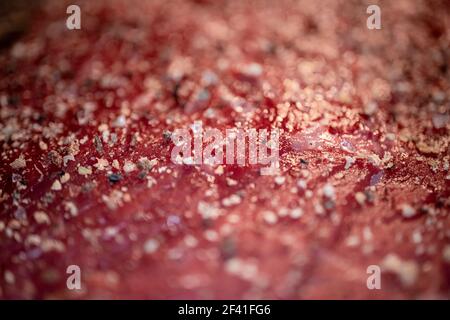 Mixed pepper and spices on the raw meat steak close up Stock Photo