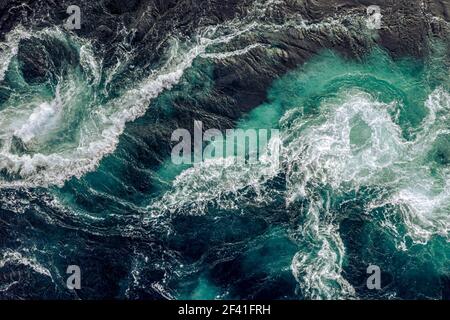 Abstract background. Waves of water of the river and the sea meet each other during high tide and low tide. Whirlpools of the maelstrom of Saltstraumen, Nordland, Norway Stock Photo