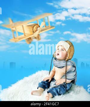 Little pilot looking at the toy aircraft Stock Photo
