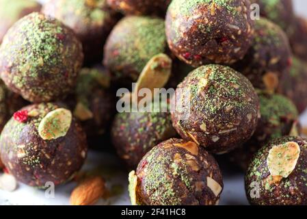 Raw energy balls with matcha tea powder on grey background. Raw vegan, vegetarian sweets. Sugar free, gluten free, lactose free Stock Photo