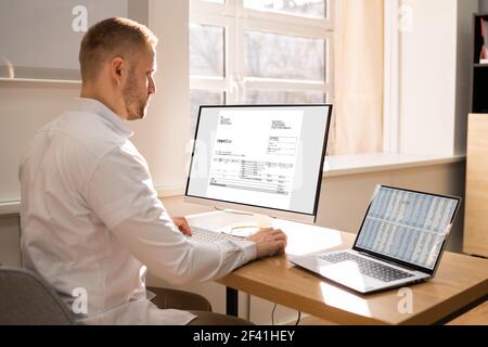 Spreadsheet Data Analyst On Working Computer Analyzing Document Stock Photo