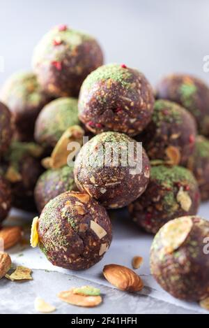 Raw energy balls with matcha tea powder on grey background. Raw vegan, vegetarian sweets. Sugar free, gluten free, lactose free Stock Photo