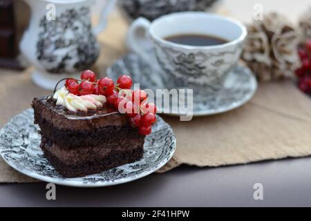 Chocolate pastry with fresh fruit served with a cup of black coffee Stock Photo