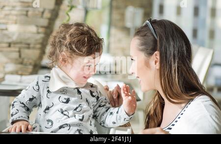 Happy mother and her little daughter having good time Stock Photo