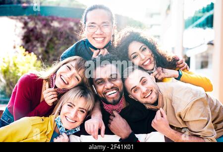 Multiracial people taking selfie with opened face mask outdoors - Happy life style concept with young students having fun together after lockdown Stock Photo