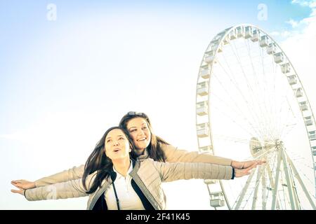 Best female friends enjoying time together outdoors at luna park  - Concept of friendship and happiness with two girlfriends having fun Stock Photo