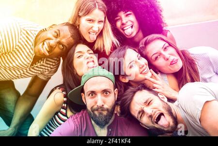Multiracial millenial friends taking selfie with funny faces - Happy youth friendship concept against racism with international young trendy people Stock Photo