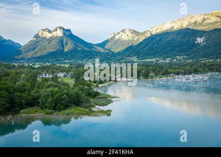 Aerial view of beautiful small town by the lake, surrounded by mountains Stock Photo