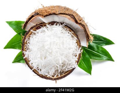 Shredded coconut flakes in the piece of coconut shell isolated on white background. Stock Photo
