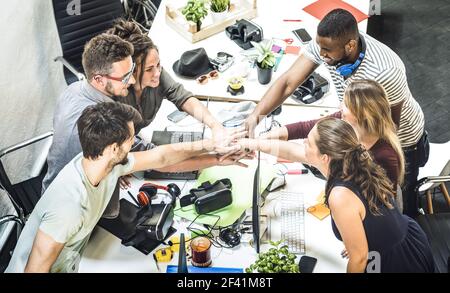 Young employee startup workers group stacking hands at urban studio during entrepreneurship brainstorming project - Business concept of human resource Stock Photo