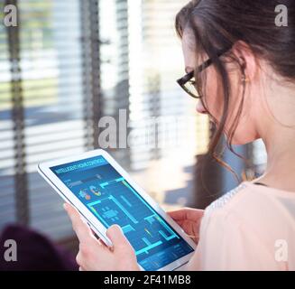 Pretty young lady using a intellignet home app Stock Photo