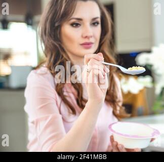 Portrait of a young woman feeding a baby Stock Photo