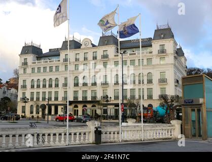 Front facade of the newly rebuilt Hotel Sardinero with flagpoles and flags on a windy March morning Santander Cantabria Spain Stock Photo