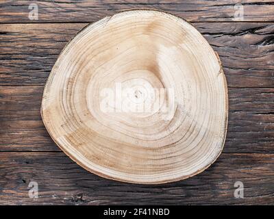 Texture of tree trunk saw cut on old wooden table. Wooden pattern in cross cut. Stock Photo