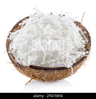 Shredded coconut flakes in the piece of coconut shell isolated on white background. Stock Photo