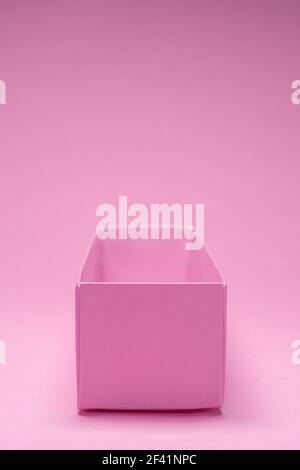 Empty open paper package box on pink background. Stock Photo
