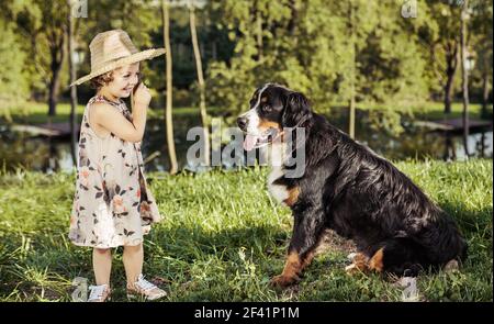 Portrait of a cute, little girl with a friendly dog Stock Photo