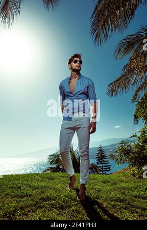 Handsome guy relaxing on vacation in a tropical place Stock Photo