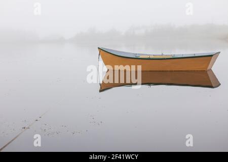 rowboat in the fog moored on a pond , Point Verde, Newfoundland, Canada Stock Photo