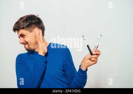 man holding toothbrushes Stock Photo