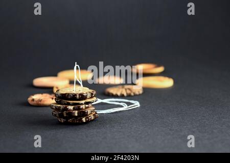 Accessories for sewing and needlework. Collection of beautiful buttons and one needle with white thread on gray background. Close-up. Selective focus. Stock Photo