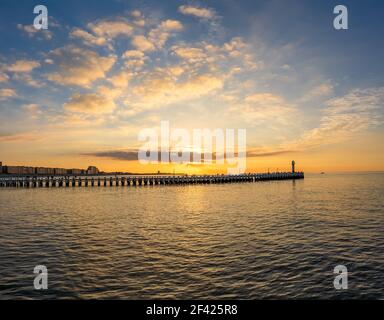 Sunset over the old wooden pier of Nieuwpoort, Belgium. Stock Photo
