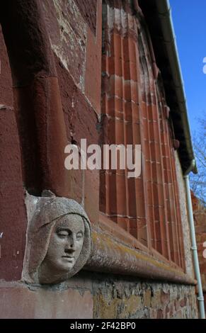 Female gargoyle head on side of St Marys Church Acton Burnell, Shropshire Stock Photo