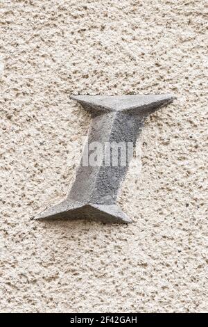 Large letter I(i) on roughly plastered wall Stock Photo