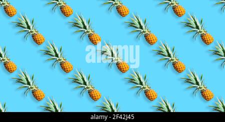 Pattern of ripe pineapples isolated on blue background. Seamless pattern Stock Photo
