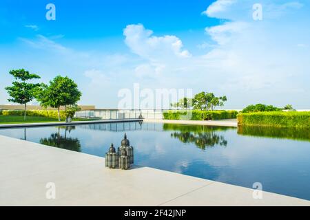 Ajman, United Arab Emirates - 30 October 2018: Landscape with lagoon pool and garden in a luxury hotel in Al Zorah coastline Stock Photo