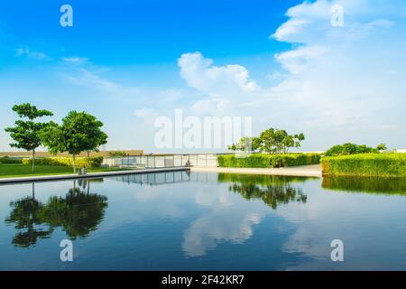 Ajman, United Arab Emirates - 30 October 2018: Landscape with lagoon pool and garden in a luxury hotel in Al Zorah coastline Stock Photo