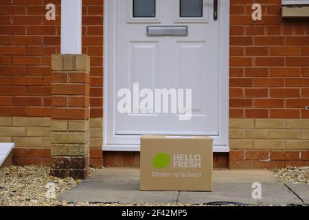 Exeter, UK-March 2021: A Hello Fresh food delivery box in front of a doorstep in Exeter. Hello Fresh supplies subscribers with recipe kit boxes