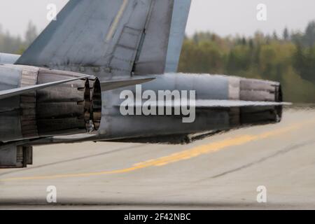 Fighter jet engine nozzles. Nozzles from two jets, one behind the other. Strong turbulence behind the nozzles. Closeup view. Stock Photo