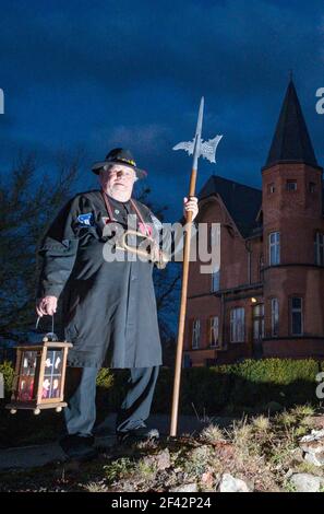 Altlandsberg, Germany. 17th Mar, 2021. Horst Hildenbrand, still acting night watchman of the town of Altlandsberg, stands with lantern, horn and halberd in the evening in front of the caretaker's house on the grounds of the former Hohenzollern Castle. For 16 years Horst Hildenbrand was night watchman in Altlandsberg. He is not a native, but came from Hesse. But he is fascinated by the history of the town of Altlandsberg, his adopted home. Now, at almost 80 years of age, he wants to pass on his office to a successor. Credit: Patrick Pleul/dpa-Zentralbild/ZB/dpa/Alamy Live News Stock Photo