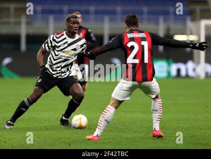 Manchester United's Paul Pogba (left) and AC Milan's Brahim Diaz battle for the ball during the UEFA Europa League Round of Sixteen match at the San Siro Stadium in Milan, Italy. Picture date: Thursday March 18, 2021. Stock Photo