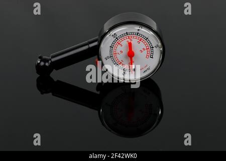 A tire pressure gauge isolated on black ground Stock Photo