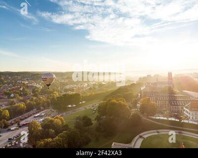 VILNIUS, LITHUANIA - AUGUST 20, 2020: Colorful hot air balloons taking off in Old town of Vilnius city on sunny summer morning. Lots of people watchin Stock Photo