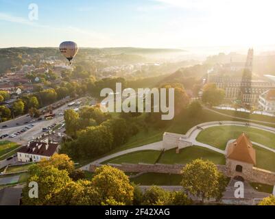 VILNIUS, LITHUANIA - AUGUST 20, 2020: Colorful hot air balloons taking off in Old town of Vilnius city on sunny summer morning. Lots of people watchin Stock Photo