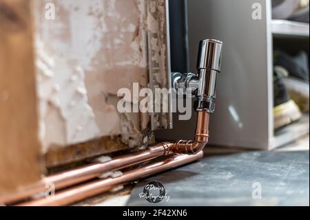 Close up of copper pipes being plumbed ready to be used on a newly fitted radiator. diy home work concept. Stock Photo