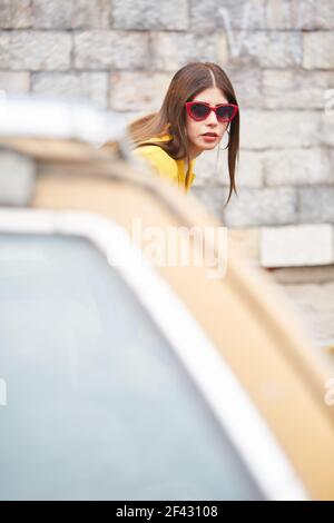 portrait young woman white with red glasses dressed in yellow color Stock Photo