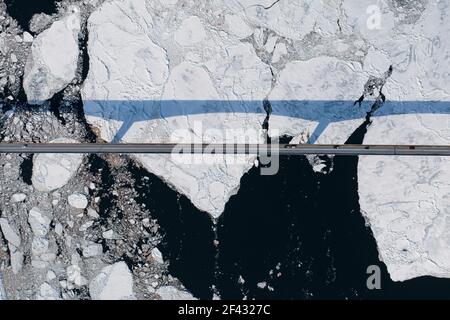 Aerial over Long Bridge and Ice Filled Bay in Canada Stock Photo