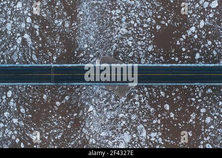 Aerial over Bridge and Ice Filled River Stock Photo