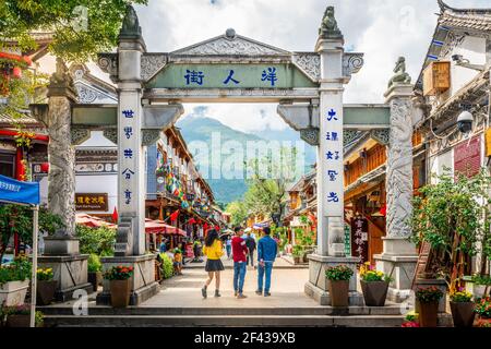 Dali China , 5 October 2020 : Dali old town road called foreigner street with stone gate people and dramatic light in Dali Yunnan China Stock Photo