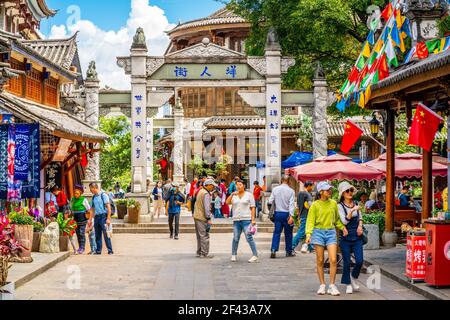 Dali China , 5 October 2020 : Beautiful foreigner street full of people with colorful old buildings and stone archway in Dali old town Yunnan China Stock Photo