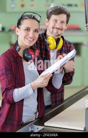 young couple with laptop in the carpenter workroom Stock Photo