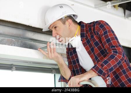 smiling foreman talking on cell phone Stock Photo