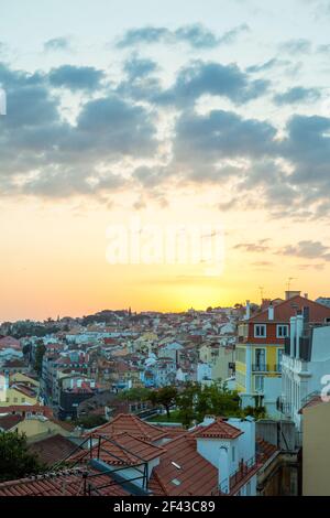 Beautiful sunset over the roofs of Lisbon, the capital city of Portugal. Stock Photo