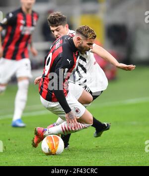 Milan, Italy. 19th Mar, 2021. AC Milan's Theo Hernandez (front) vies with Manchester United's Daniel James during the Europa League round of 16 second leg match between AC Milan and Manchester United in Milan, Italy, March 18, 2021. Credit: Xinhua/Alamy Live News Stock Photo